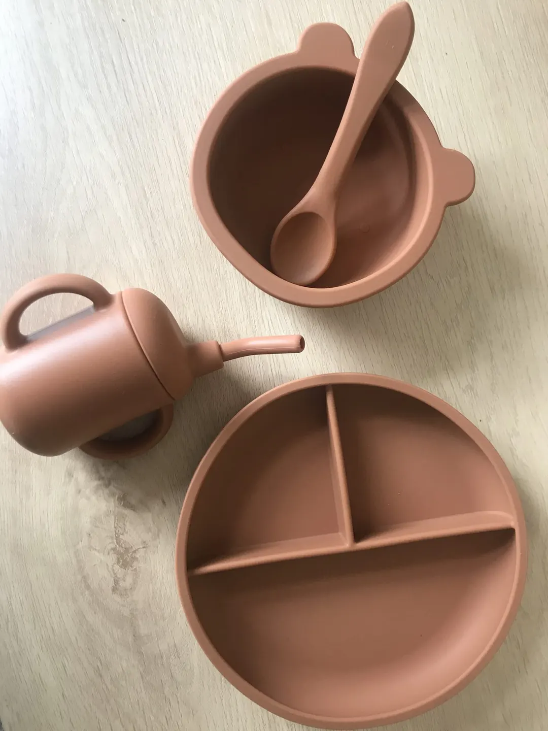 The cup alongside matching dinnerware in a real-life setting.
