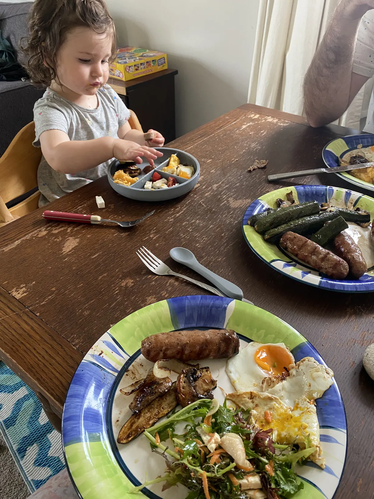 A divided plate being used during a family meal.