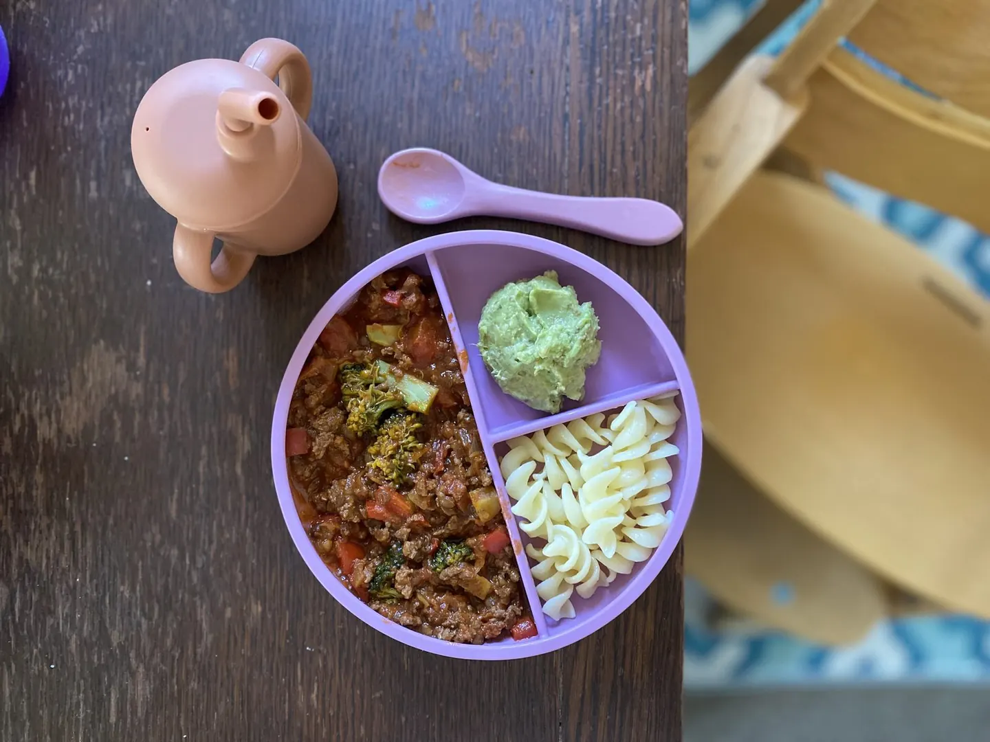 A toddler enjoying a meal with the dinnerware set.