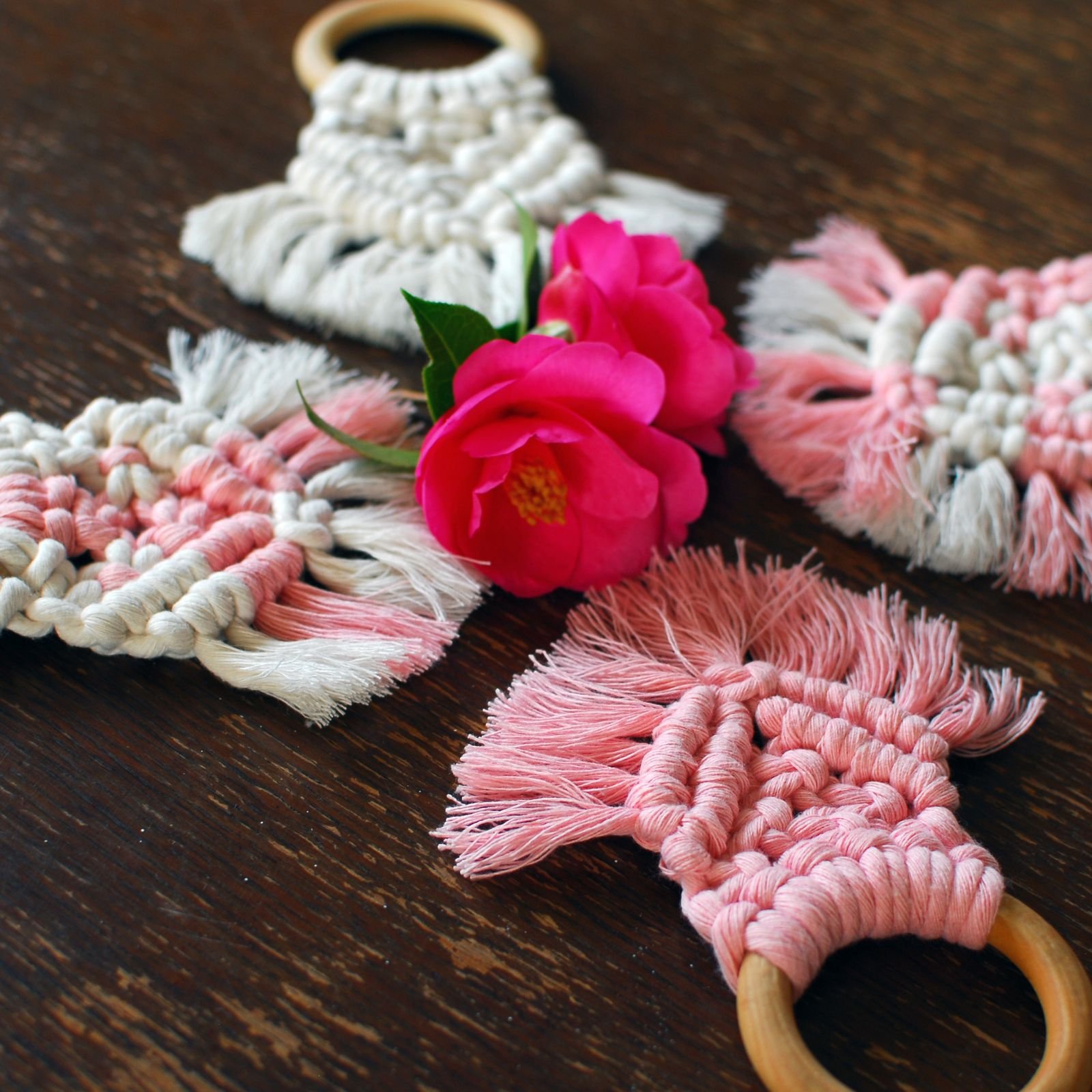 Group of natural and pink macrame teethers with flowers