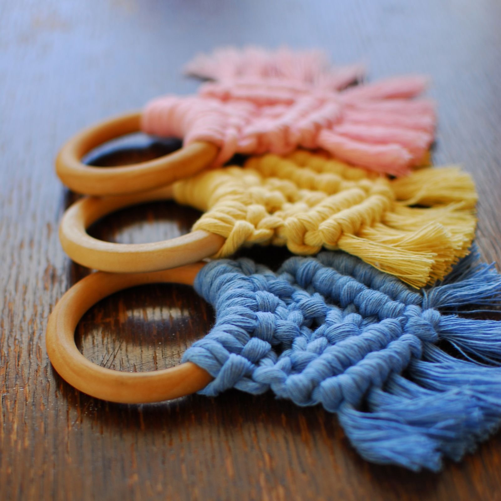 Group of Macrama teethers in blue, yellow and pink